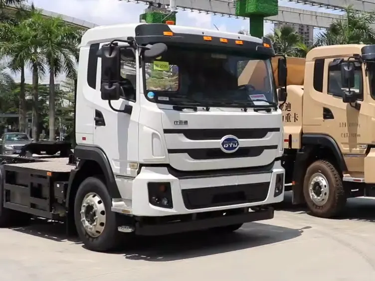 A white BYD 8TT battery-electric semi tractor parked outside BYD headquarters